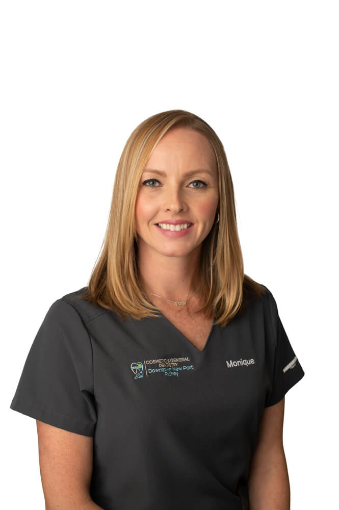 team member Monique Rivera of ESI Dentistry - Esthetic Smiles & Implants smiling in front of white background