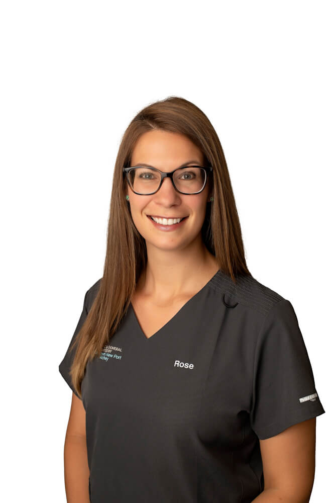 team member Rose Turner of ESI Dentistry - Esthetic Smiles & Implants smiling in front of white background