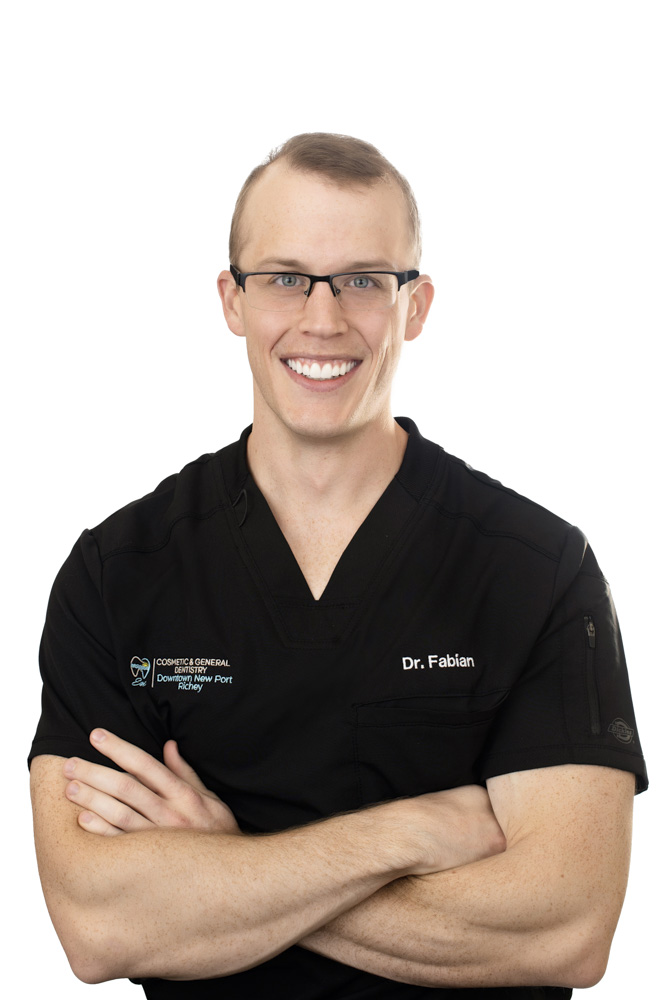 Dr. Michael Fabian of ESI Dentistry - Esthetic Smiles & Implants standing with arms crossed